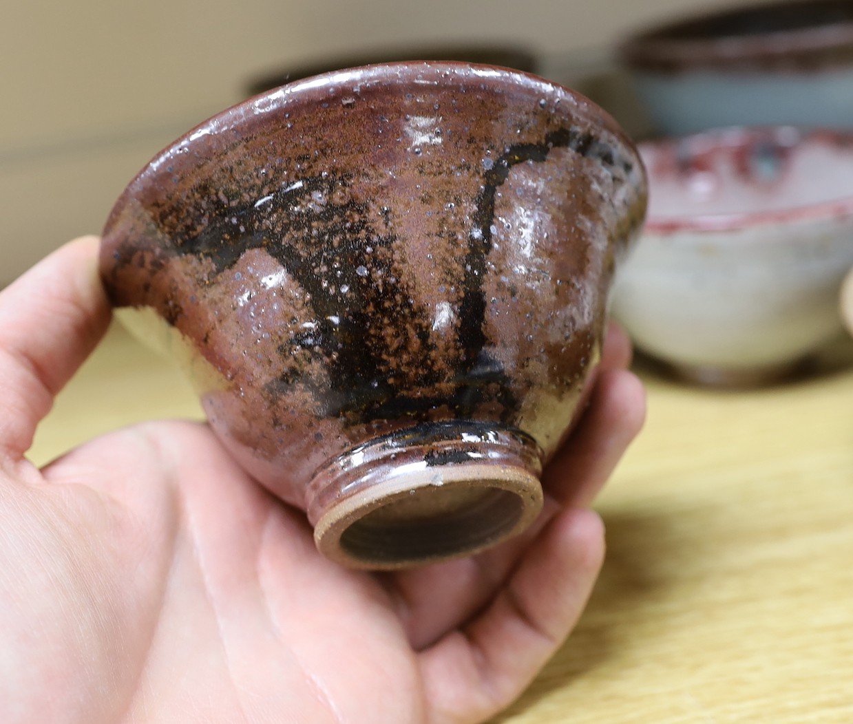 A large pottery figural tile together with a collection of studio pottery bowls